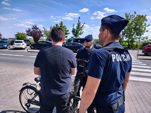 Policjanci rozmawiający z rowerzystą.