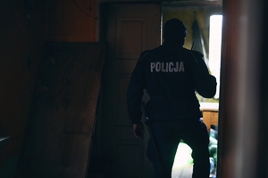 Policjant kontrolujący pustostan.