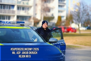 Dzielnicowy przy radiowozie.