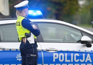 Policjantka przy radiowozie.